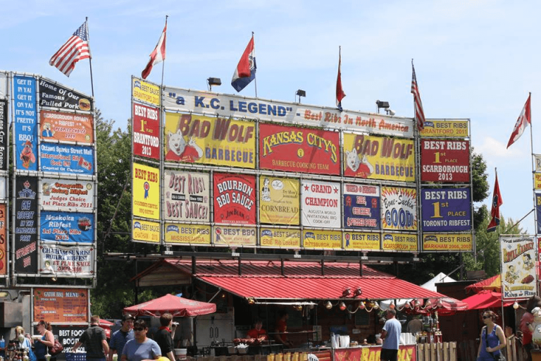 Crowd gathered at Brantford Ribfest in Ontario with food vendors and signage
