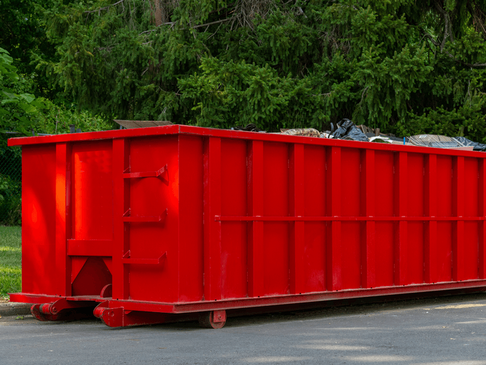 Loaded red 30 yard dumpster