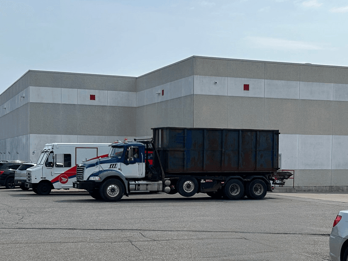 Delivery of rental commercial roll-off dumpster bin