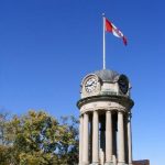 Victoria Park clock tower in Kitchener, Ontario flying the Canadian flag